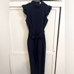 Cropped pant navy jumpsuit with tie and ruffled sleeves. Size S